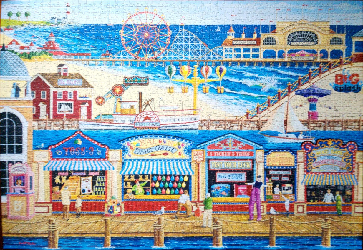 A whimsical, colourful illustration of a busy boardwalk with carnival games, a pier, and an amusement park by the sea.