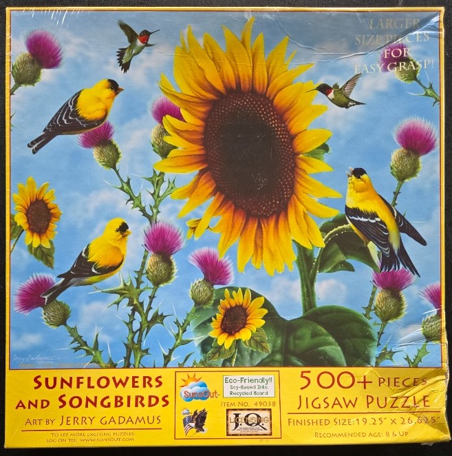 A vibrant nature scene featuring a large sunflower, songbirds, and purple thistle flowers against a blue sky.