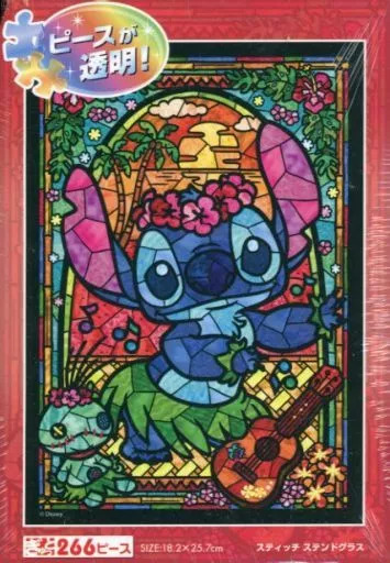 Stained glass style illustration of the character Stitch wearing a hula skirt and playing a ukulele at sunset.