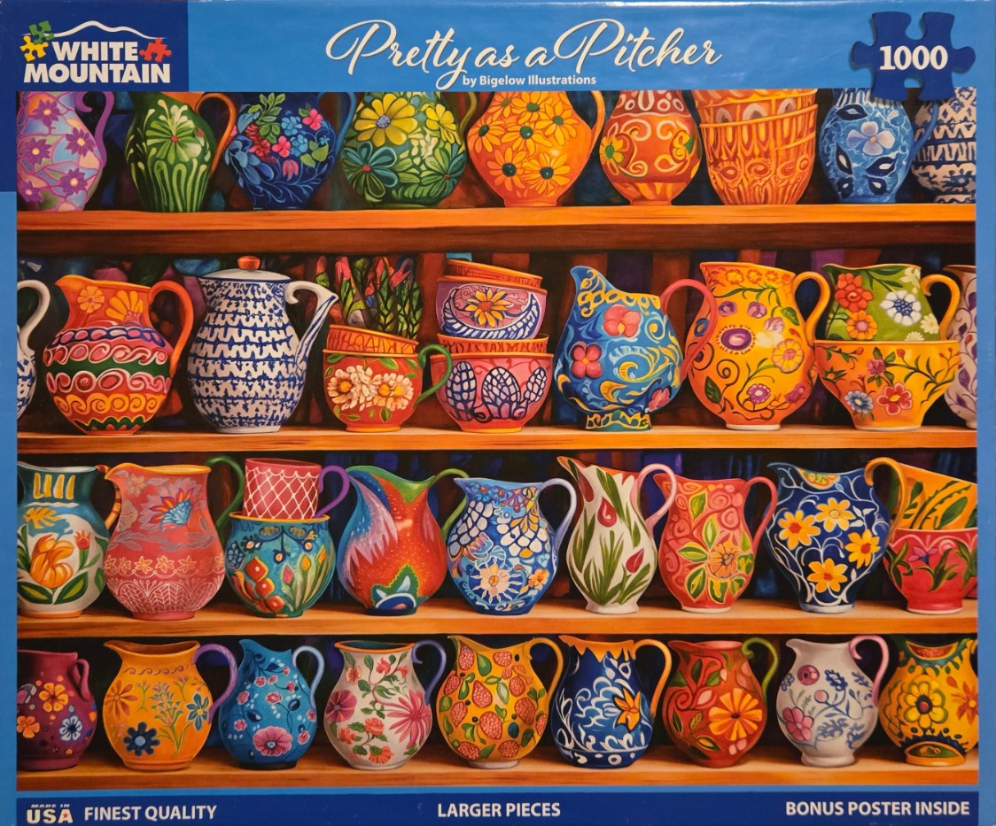 A collection of colorful, decorative ceramic pitchers and bowls arranged on wooden shelves.