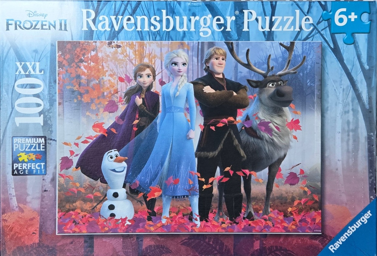 Elsa, Anna, Kristoff, Sven, and Olaf from Frozen 2 standing in an autumn forest.