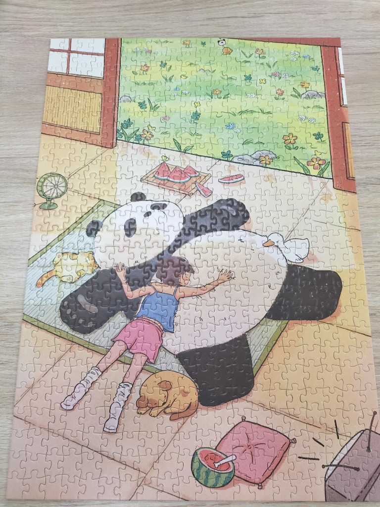 A girl lies on a giant panda inside a cozy home with a view of a sunny garden.