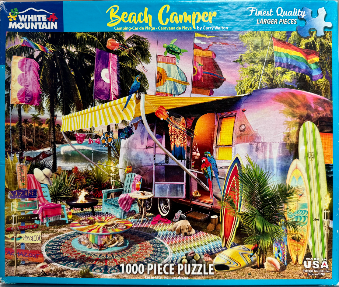 A vintage metal trailer parked on a beach at sunset with surfboards, a campfire, and tropical parrots.