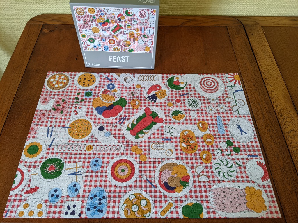 Top-down view of a feast illustration on a red and white checkered tablecloth