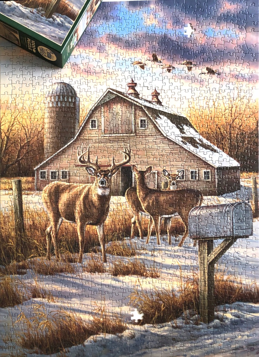 A rural winter scene with a large barn, three deer, and a flock of geese in a sunset sky.