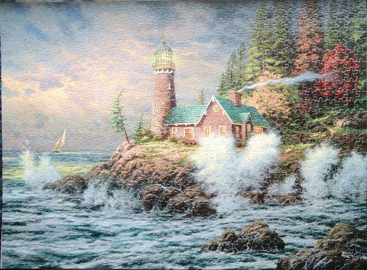 A stone lighthouse and cottage stand on a rocky cliff overlooking a stormy ocean at sunset.