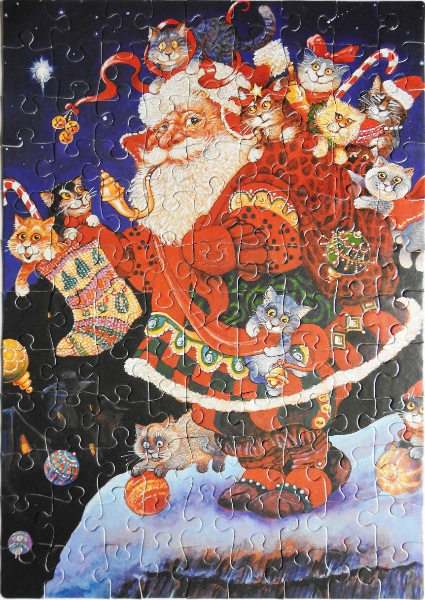 Santa Claus surrounded by many kittens in a dark, festive night scene.