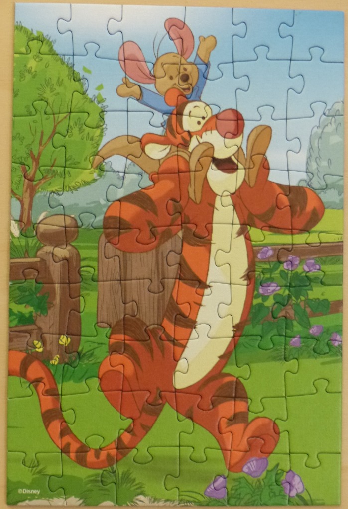 Tigger carrying Roo on his shoulders in a sunny garden setting