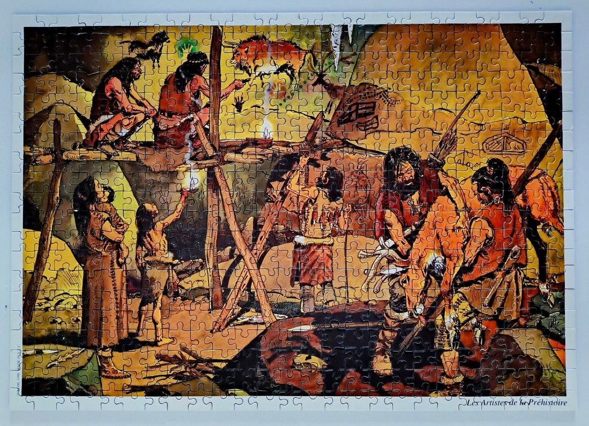 Prehistoric artists painting on the wall of a cave