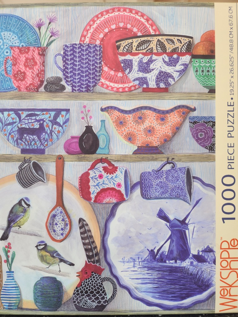 A whimsical illustration of three shelves filled with patterned pottery, ceramic bowls, mugs, and small bird illustrations.