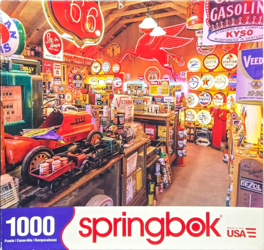 A cluttered vintage gas station memorabilia shop filled with neon signs and antique toy cars.