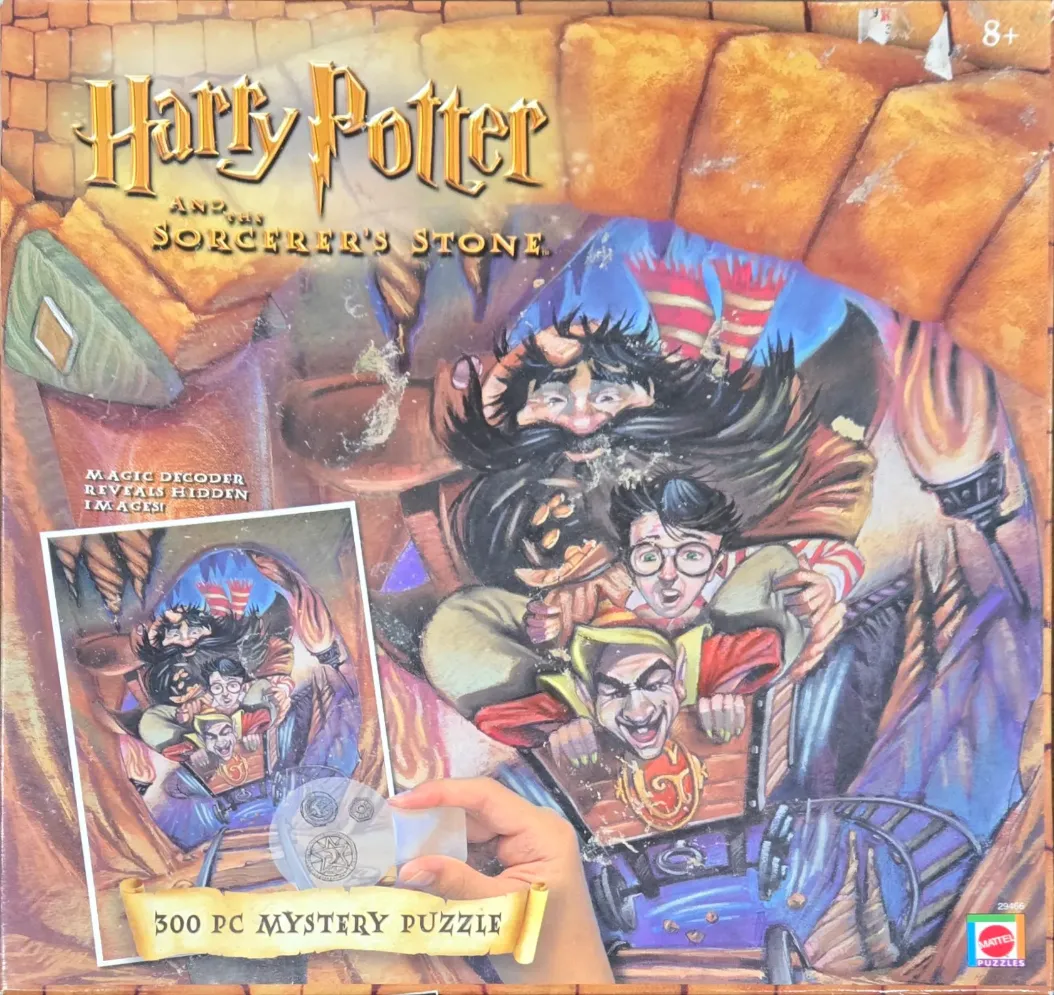 Illustration of Harry Potter and Hagrid riding a mine cart through a stone tunnel.