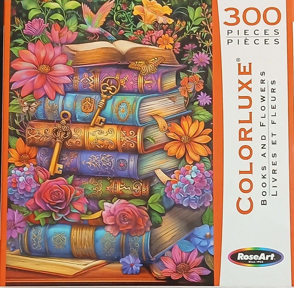 A stack of colorful, ornate antique books surrounded by vibrant flowers, butterflies, and an open book on top.