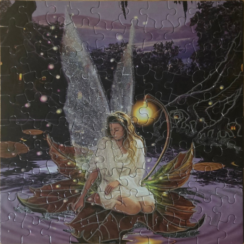 A fairy with iridescent wings sits on a large lily pad in a dark, magical pond at dusk.