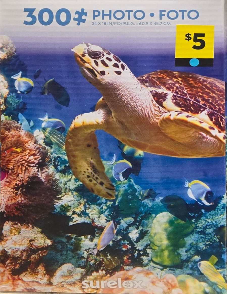 A sea turtle swimming near a colorful coral reef with various tropical fish.
