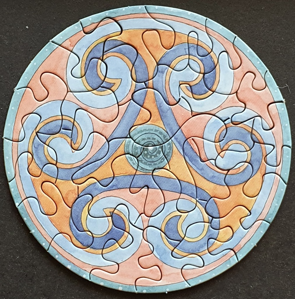 Circular Celtic-inspired artwork featuring a triskelion design in shades of blue and orange.