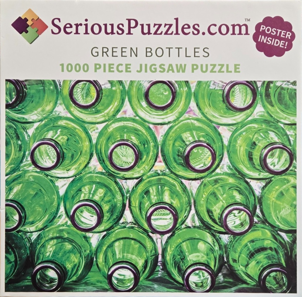 Close-up photograph looking directly down into the necks of many stacked green glass bottles