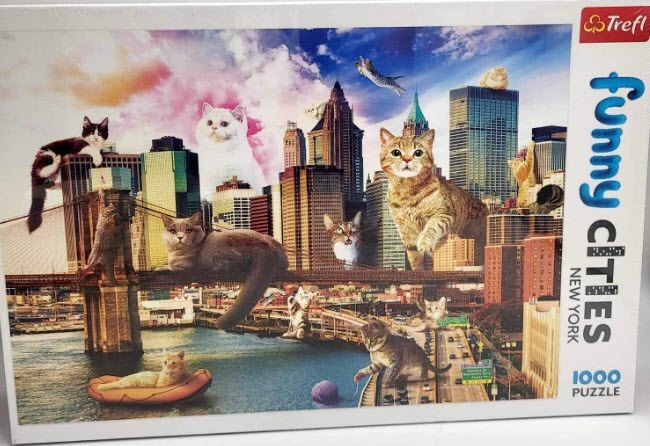 A whimsical collage of giant cats interacting with the New York City skyline at sunset.