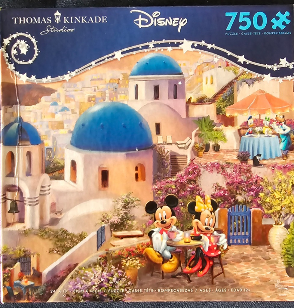 Mickey and Minnie Mouse at a cafe overlooking a scenic Greek island village with blue domes.