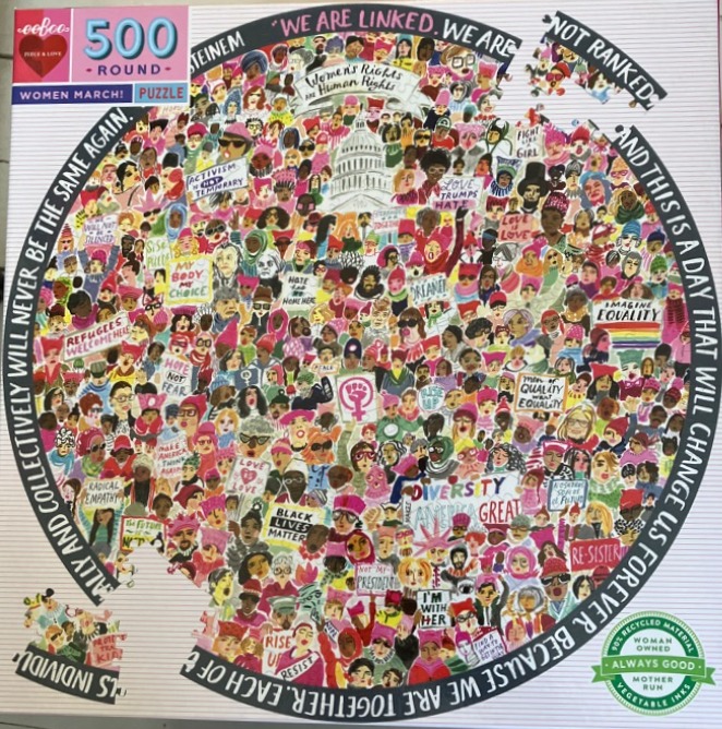 An illustration of a dense crowd of diverse women at a protest, arranged in a circular formation with text along the edge.
