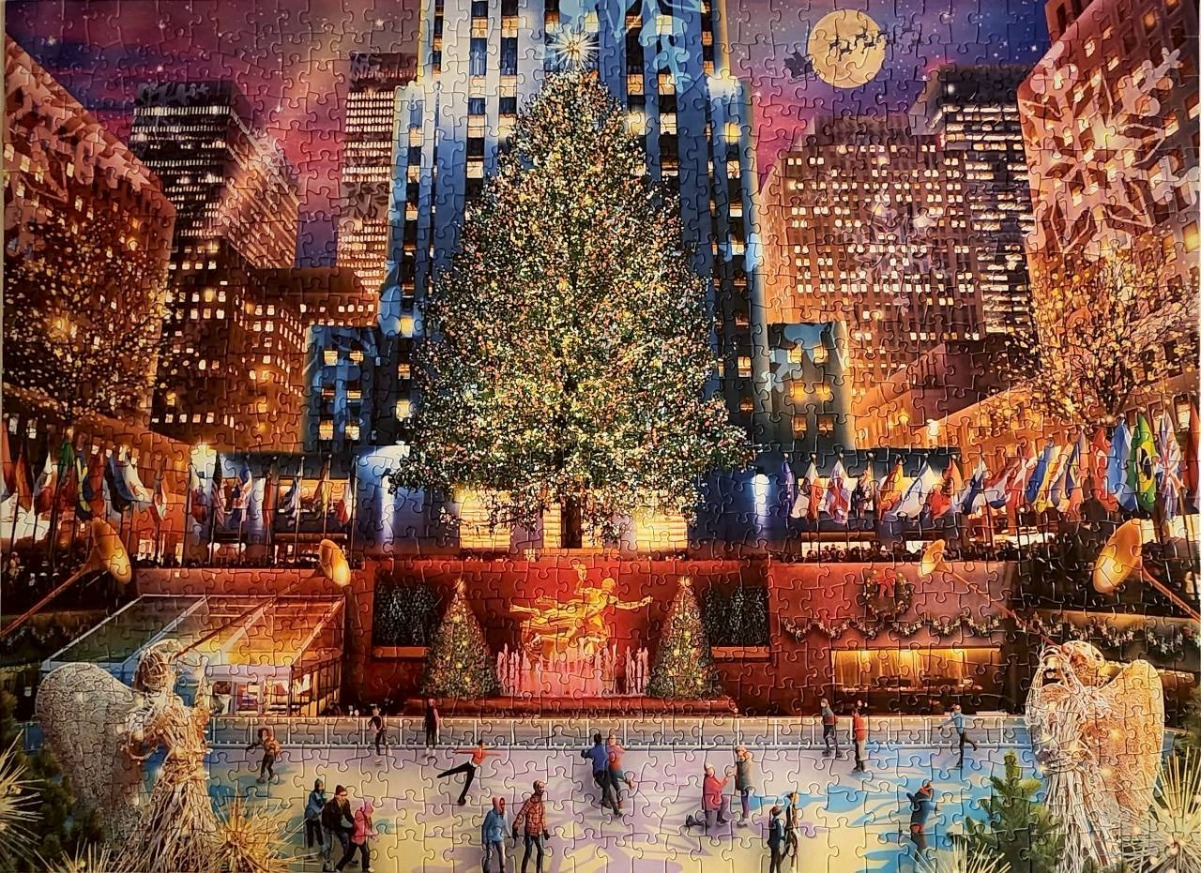 A Christmas scene at Rockefeller Center in New York City with a large tree, ice skating rink, and golden statue.
