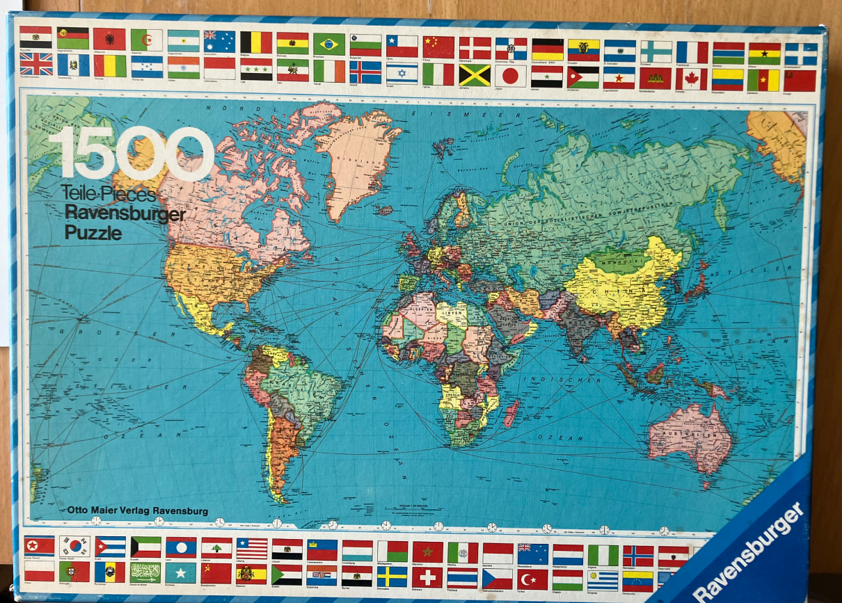 A vintage world map illustration bordered by rows of national flags from around the globe.