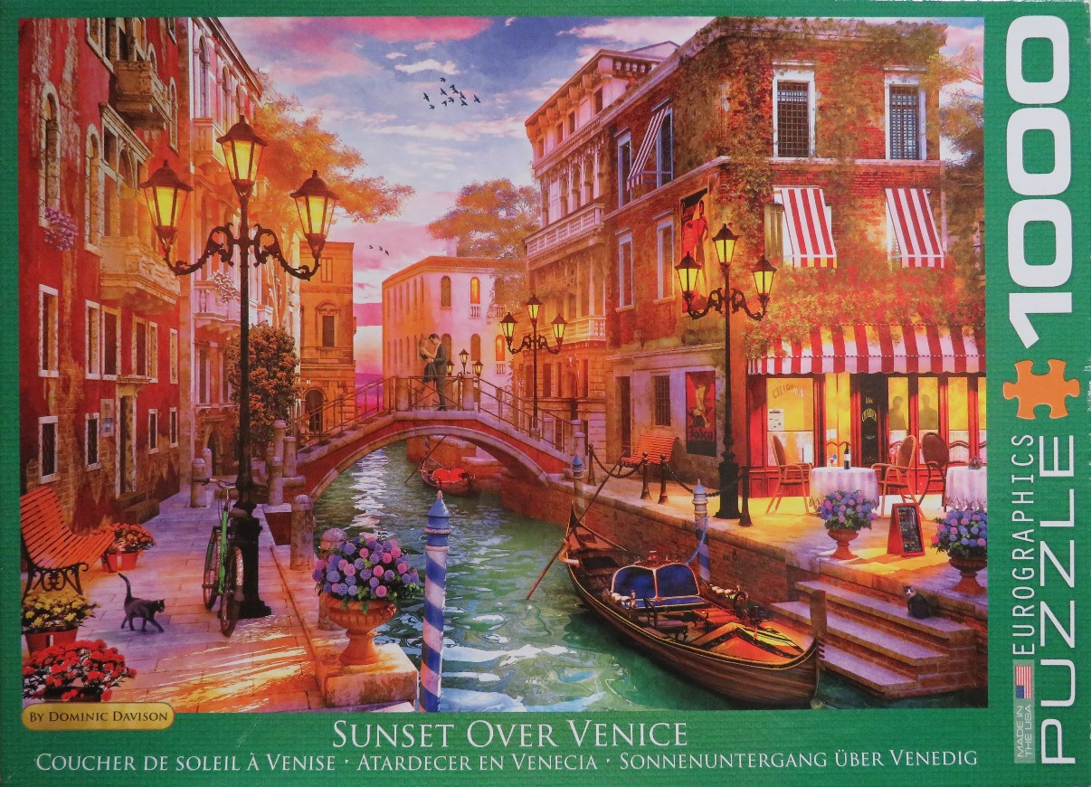 Romantic Venetian canal scene at sunset with buildings, a bridge, and a gondola.