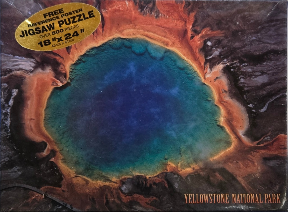 Aerial view of the Grand Prismatic Spring in Yellowstone National Park with vibrant blue and orange mineral rings.