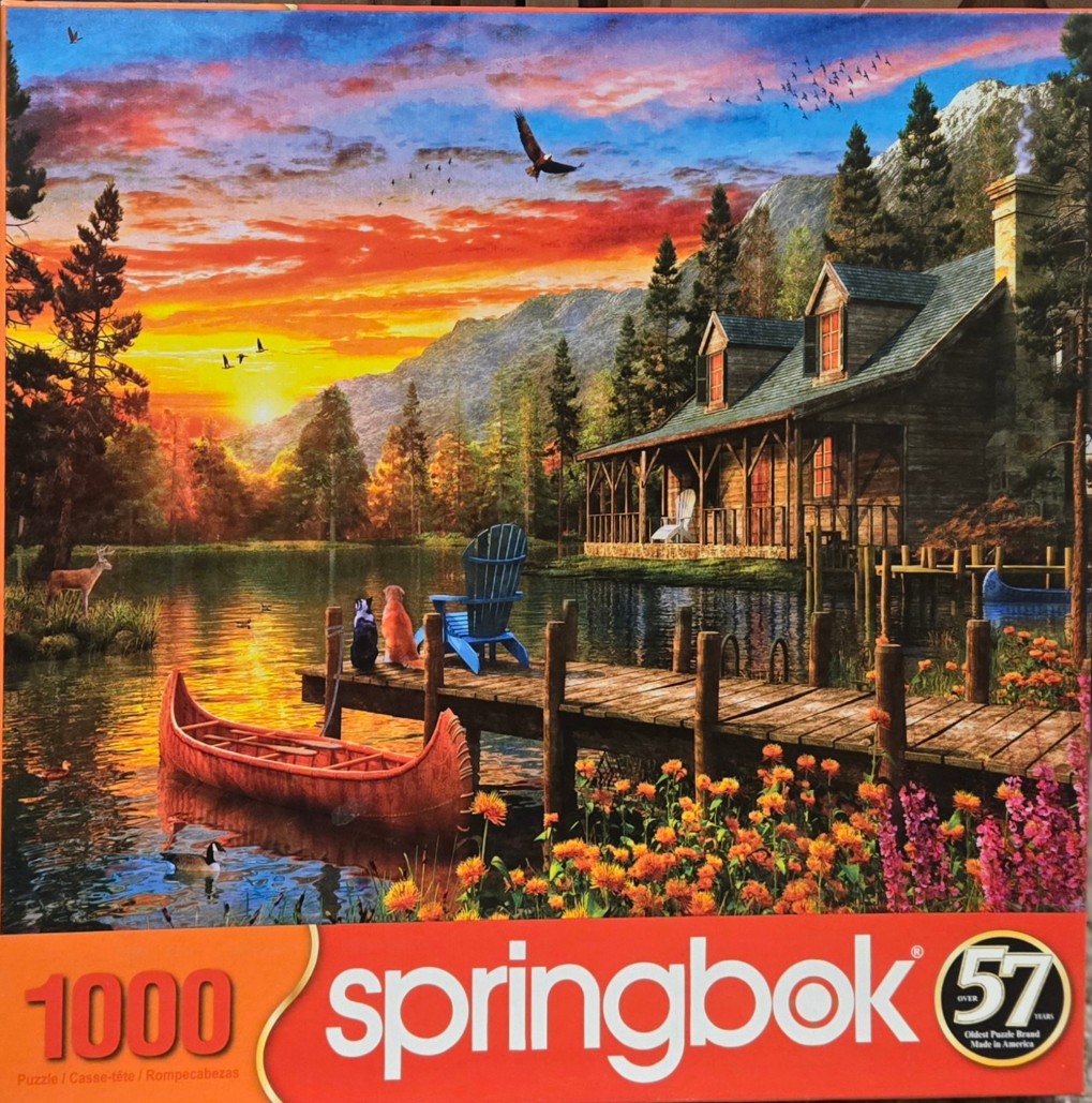 A peaceful lakeside cabin scene at sunset featuring a wooden dock, a red canoe, a dog, a cat, and a mountainous backdrop.