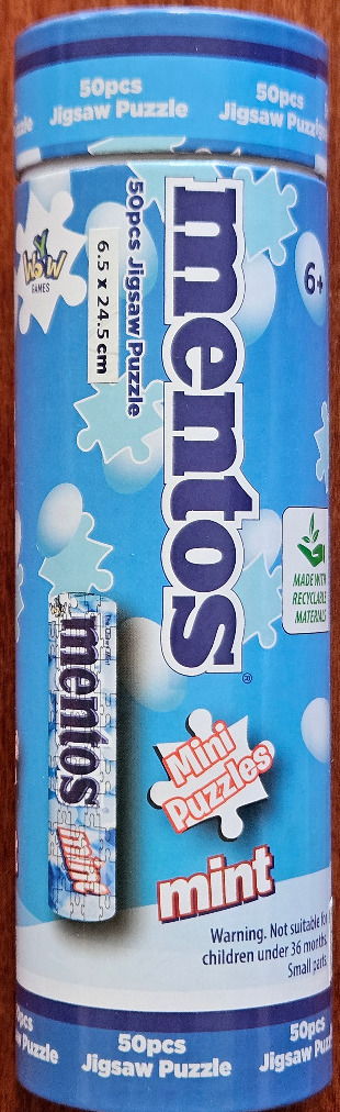 Cylindrical package featuring Mentos candy branding and jigsaw puzzle imagery in shades of bright blue and white.
