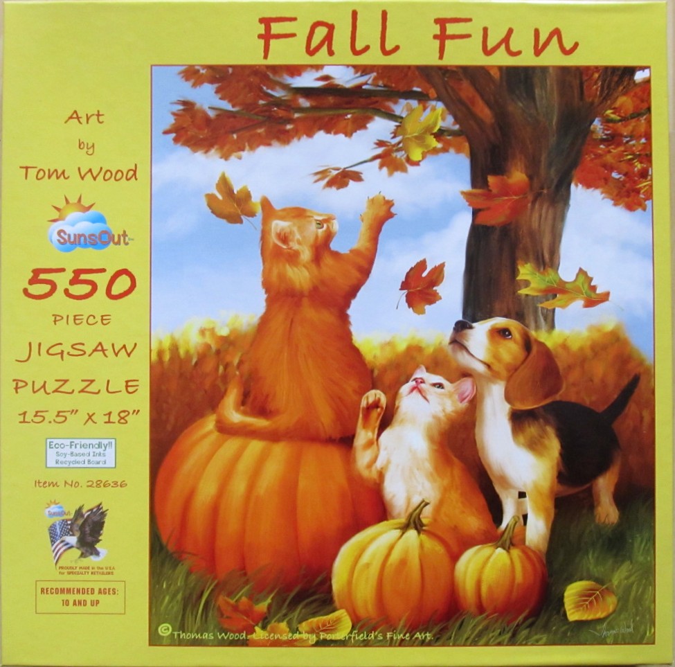 Two ginger kittens and a beagle puppy play with falling autumn leaves around several large pumpkins.