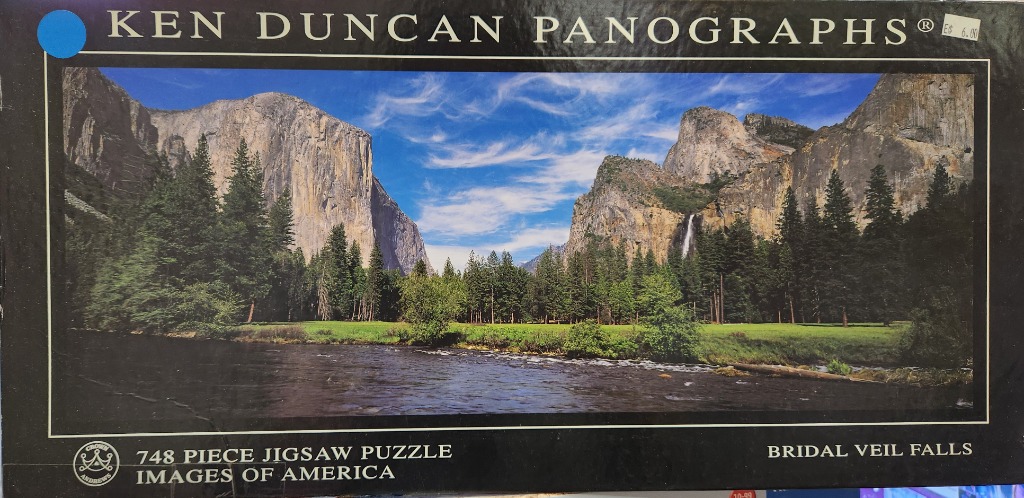 Panoramic photograph of Yosemite Valley featuring the massive granite cliffs of El Capitan and Bridalveil Fall.