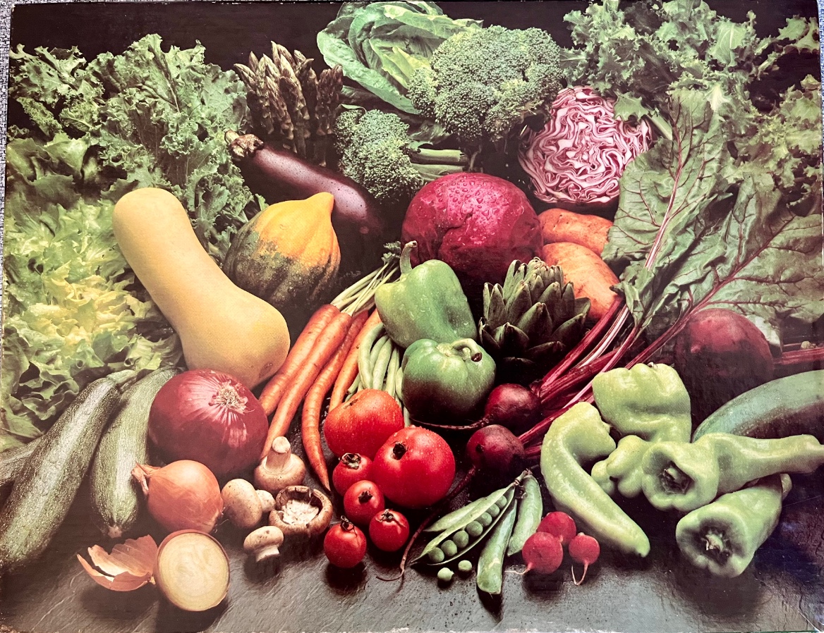 A vibrant assortment of fresh vegetables arranged against a dark background.