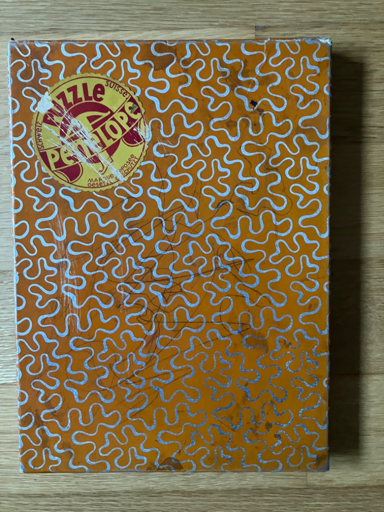 A repeating pattern of silver, squiggly organic shapes on a solid orange background.