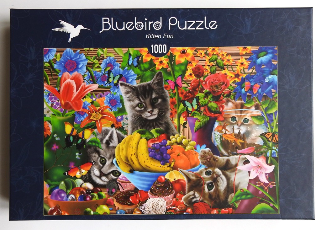Three kittens playing amidst a vibrant collection of flowers, fruits, and colorful butterflies.