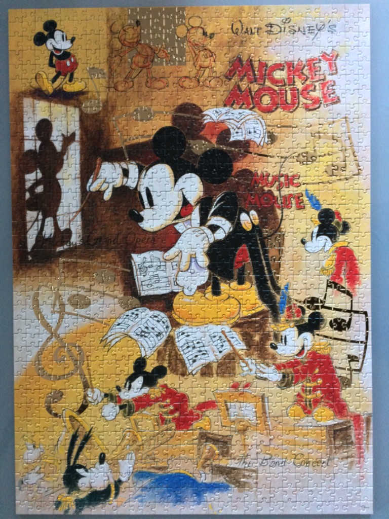 A collage of Mickey Mouse in various musical and performance roles with a golden, sketch-like background.