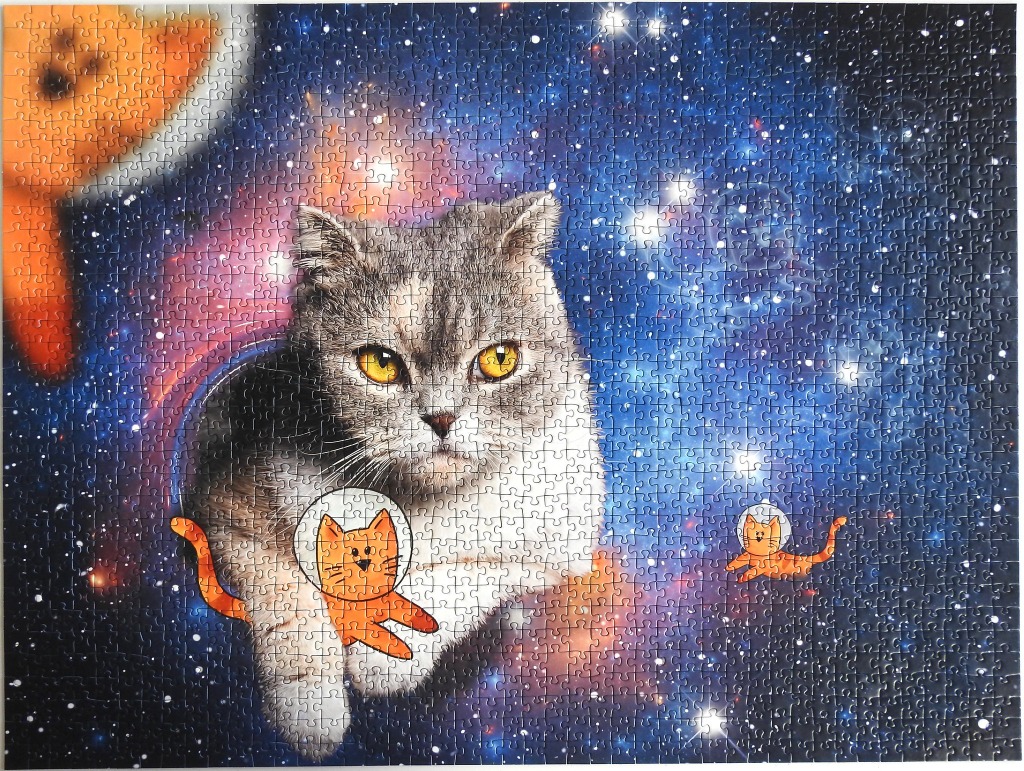 A realistic cat floating in deep space next to two small, cartoon-style orange space cats.