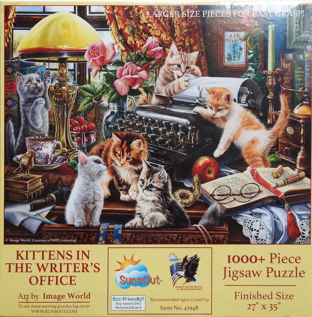 Five kittens playing with a typewriter and books on a cluttered antique desk.