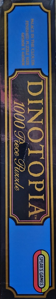 "Dinotopia" 1000 piece puzzle box featuring gold text on black with blue accents.