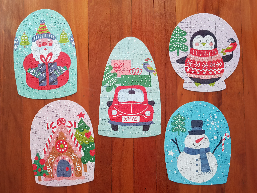 Five holiday-themed snow globe illustrations featuring Santa, a car, a penguin, a gingerbread house, and a snowman.