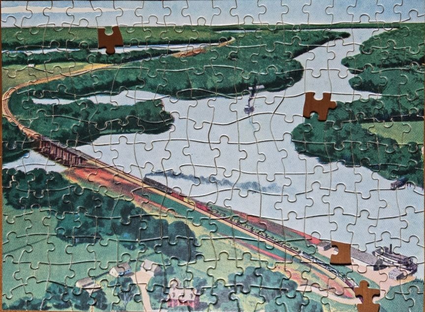 An aerial illustration of a train crossing a long trestle bridge over a river surrounded by lush green landscape.