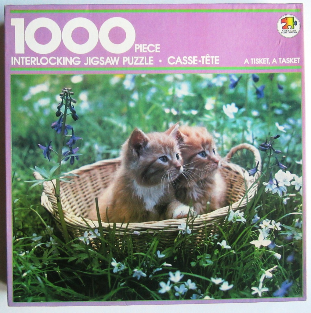 Two fluffy ginger kittens sitting together in a wicker basket in a field of wildflowers.