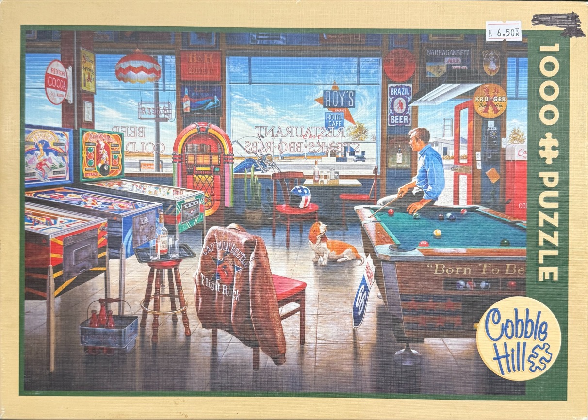 Interior view of a vintage diner-style pool hall featuring a man playing pool, a jukebox, and a basset hound.
