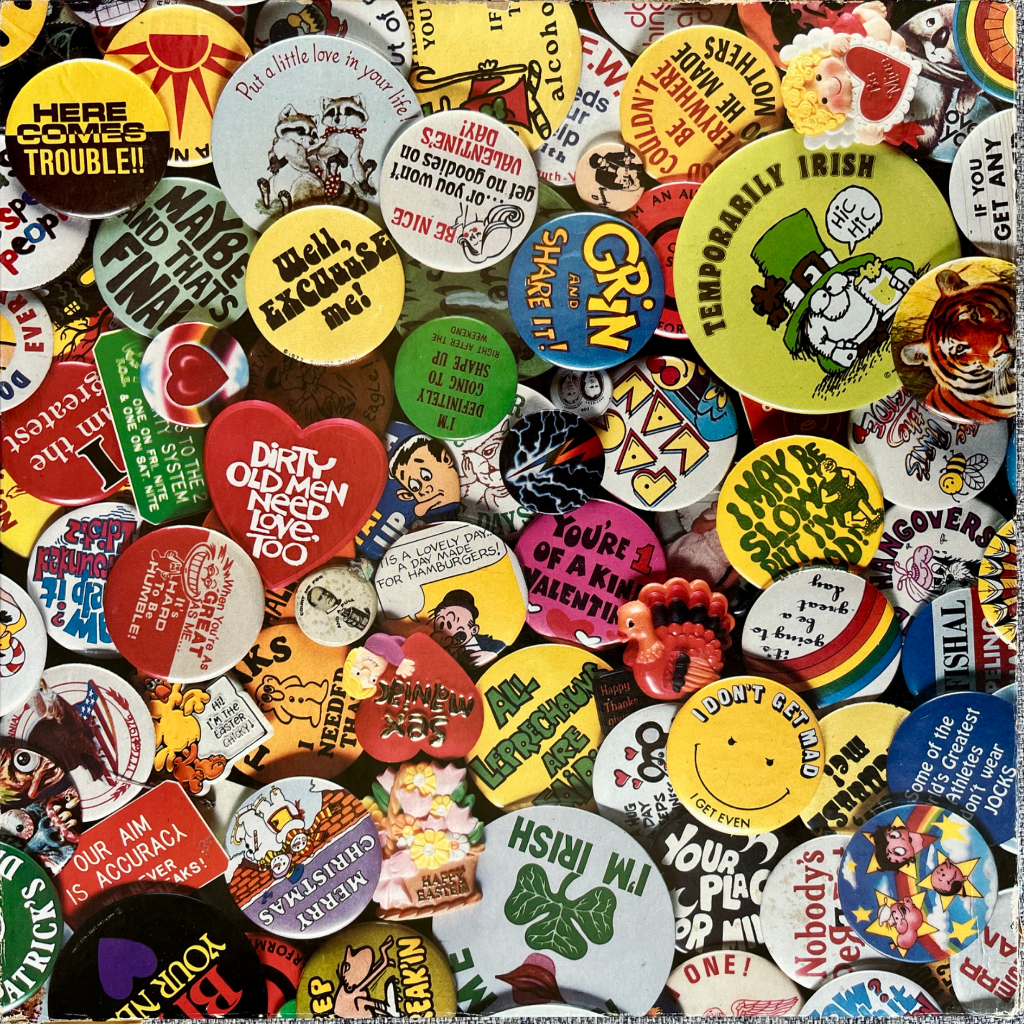 A dense, colorful collage of numerous vintage pinback buttons featuring various slogans, cartoons, and holiday themes.
