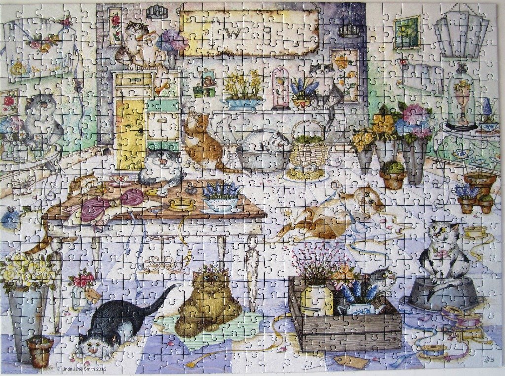 Whimsical illustration of numerous cats exploring a sunlit room filled with flowers and craft supplies.