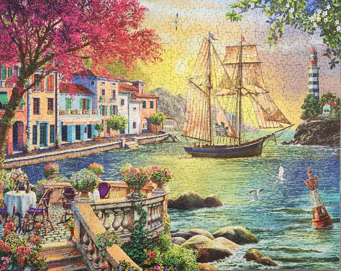 A Mediterranean harbor scene with a sailboat, a lighthouse, and a flower-filled terrace at sunset.