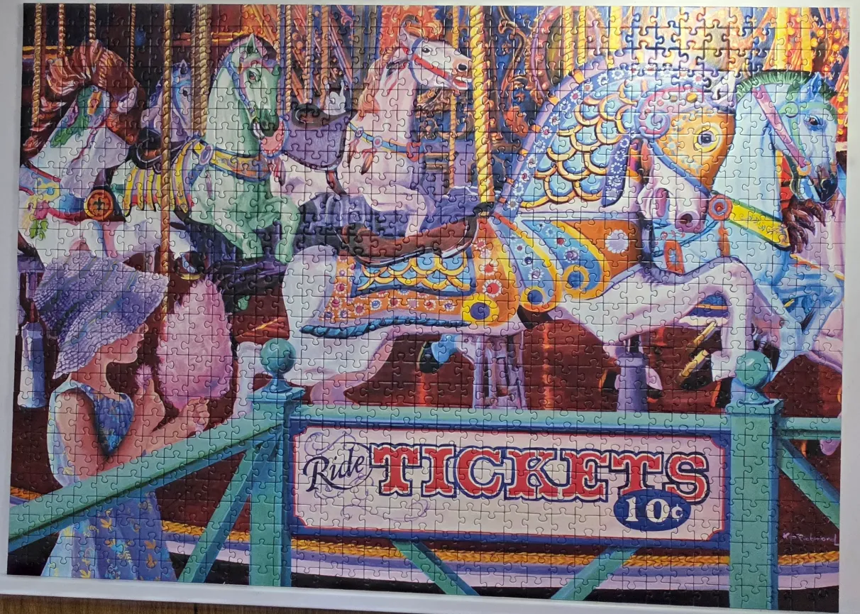 An illustration of a girl holding cotton candy in front of a vintage carousel with several brightly colored horses.