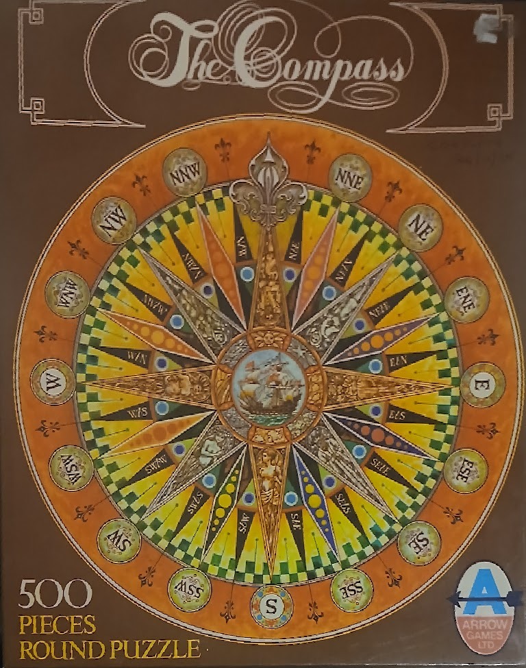 Circular nautical compass rose with intricate maritime illustrations and cardinal directions against a warm brown background.
