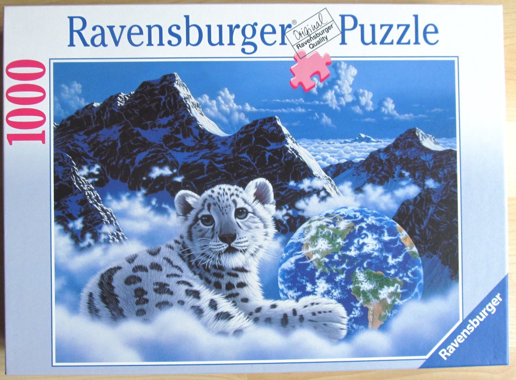 A snow leopard cub resting on clouds in front of Earth and snow-capped mountains.