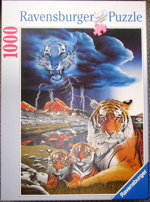 A mother tiger and two cubs sit in a mountainous landscape beneath a stormy sky with a ghostly, superimposed tiger face.